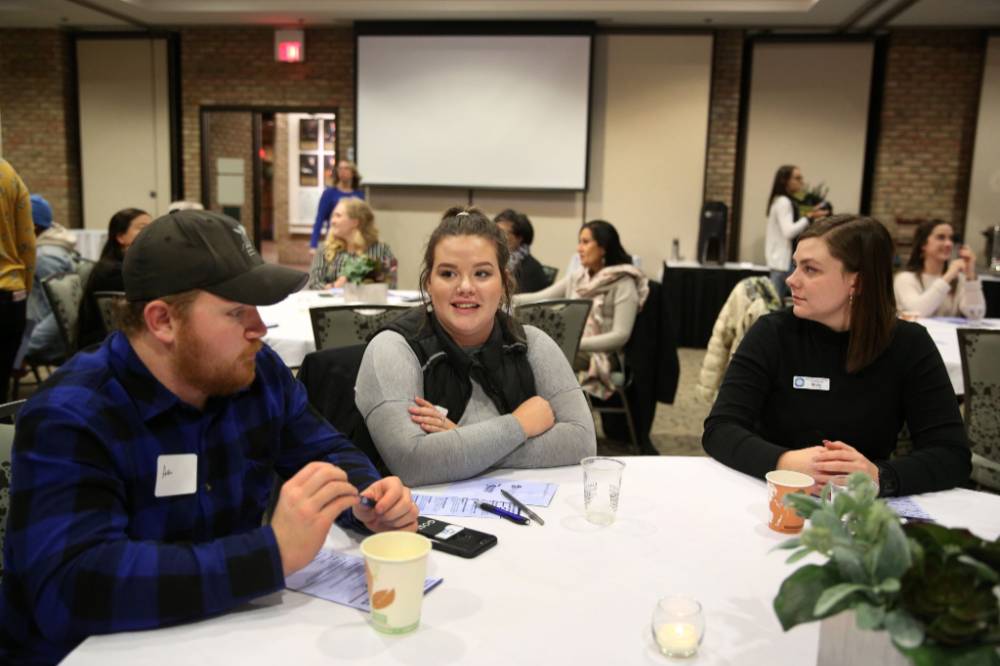 Three students practice civil discourse at their table